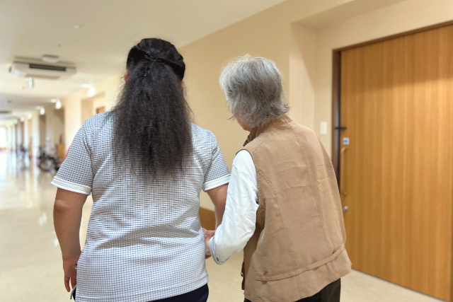 利用者様に寄り添いながら歩くK・Pさんの様子